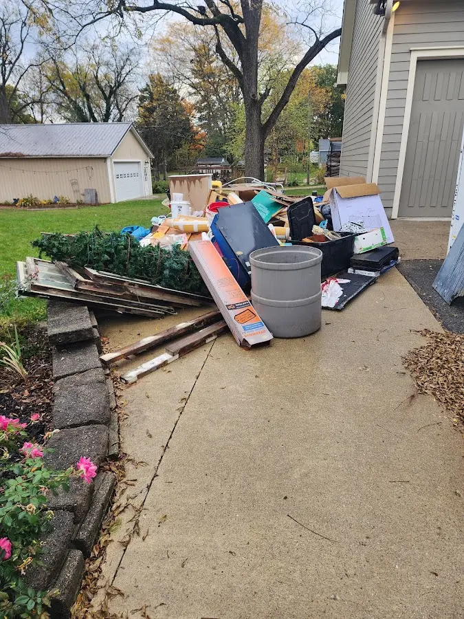 Dumpster being loaded with debris for Estate Cleanout Dumpster Rental in Toppenish